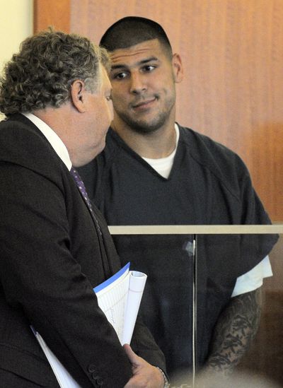 Former NFL player Aaron Hernandez, right, talks to his attorney during a bail hearing on Thursday. (Associated Press)