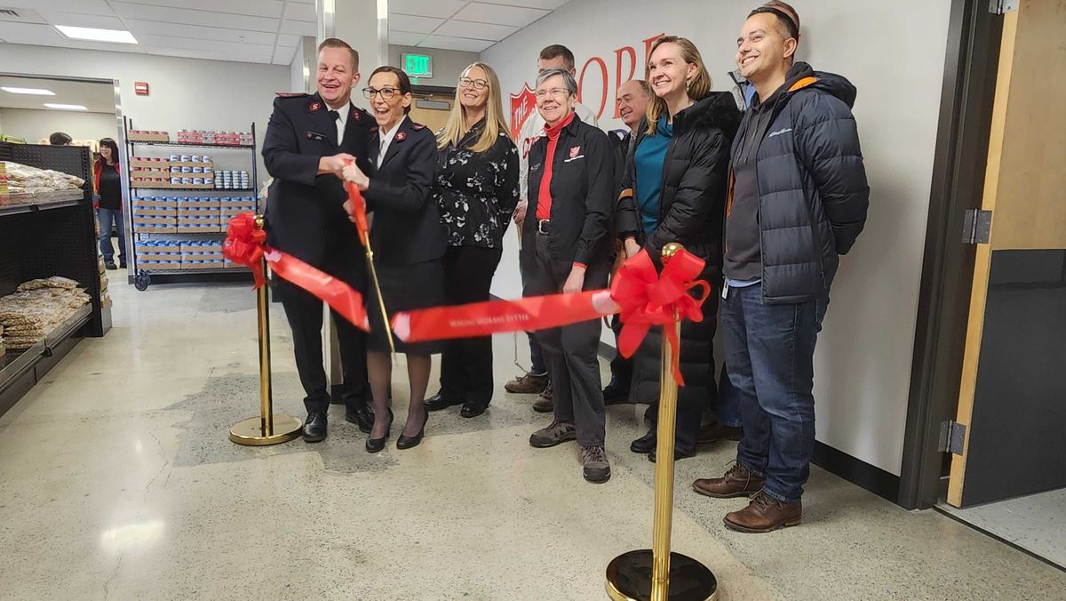 The Hope Market food pantry officially opened Wednesday. Cutting the ribbon are David Cain and wife Kelly Cain, both corps officers in the Salvation Army.  (Cannon Barnett/The Spokesman-Review)