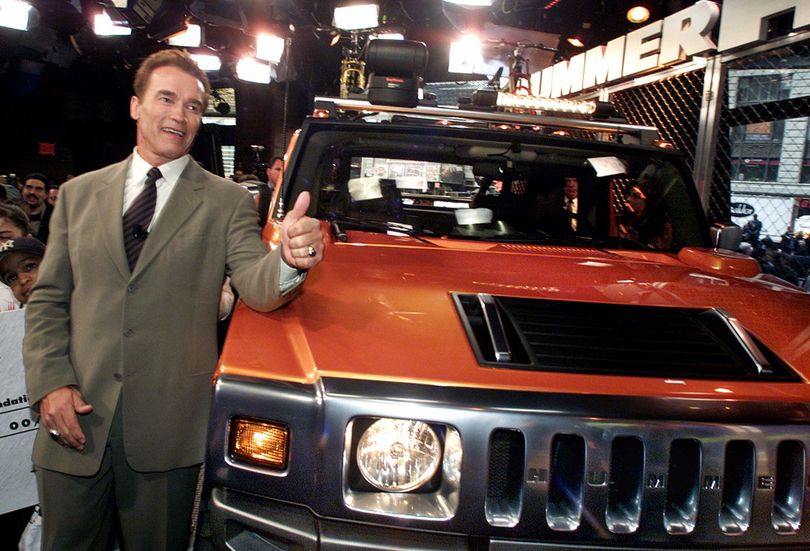 FILE - In this April 10, 2001 file photo, Arnold Schwarzenegger poses with a 2001 concept Hummer H2 at the utility vehicle's unveiling in New York's Times Square. The Hummer, the beefy, military-inspired SUV _ a macho icon for fans like Schwarzenegger and a symbol of ruin for environmentalists _ was done in by high gas prices and bad economic times. Unless a last-minute buyer steps forward, Hummer is going the way of Saturn and Pontiac. (Richard Drew / Associated Press)