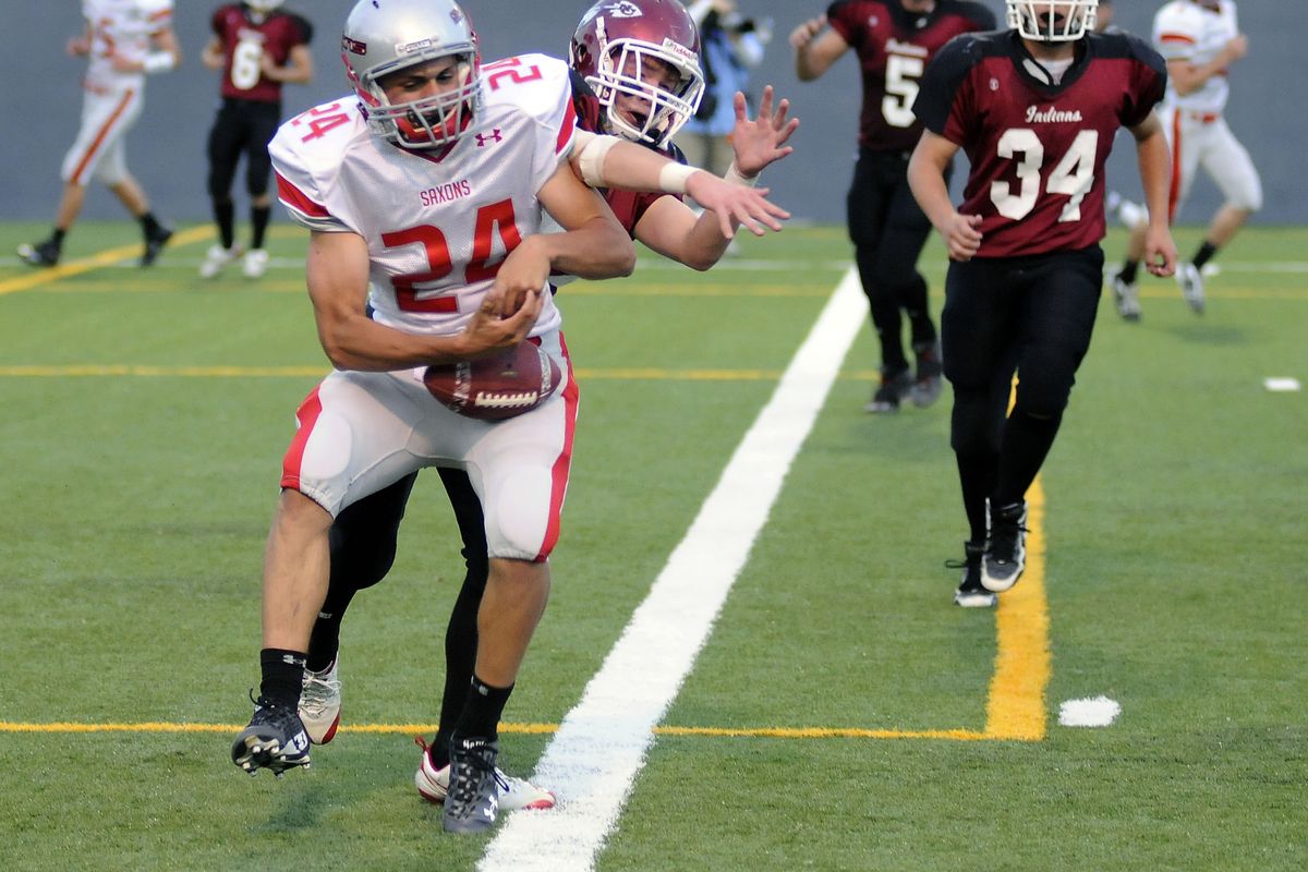 Ferris wide receiver Jordan Tonani fights off North Central’s Sam Cropper to catch a touchdown pass. (Dan Pelle / The Spokesman-Review)