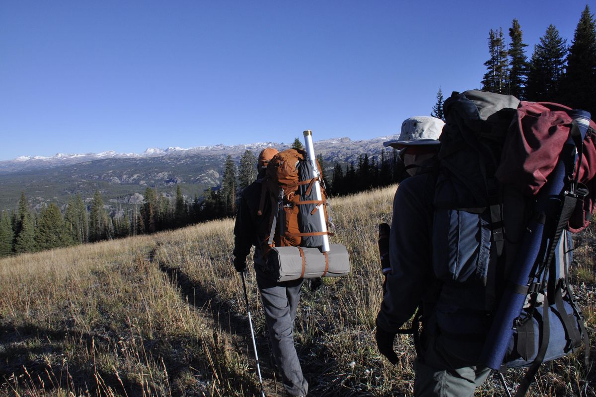 Backpacking anglers hike toward the high lakes of the Absaroka-Beartooth Wilderness plateau.  RICH LANDERS PHOTO (SR)