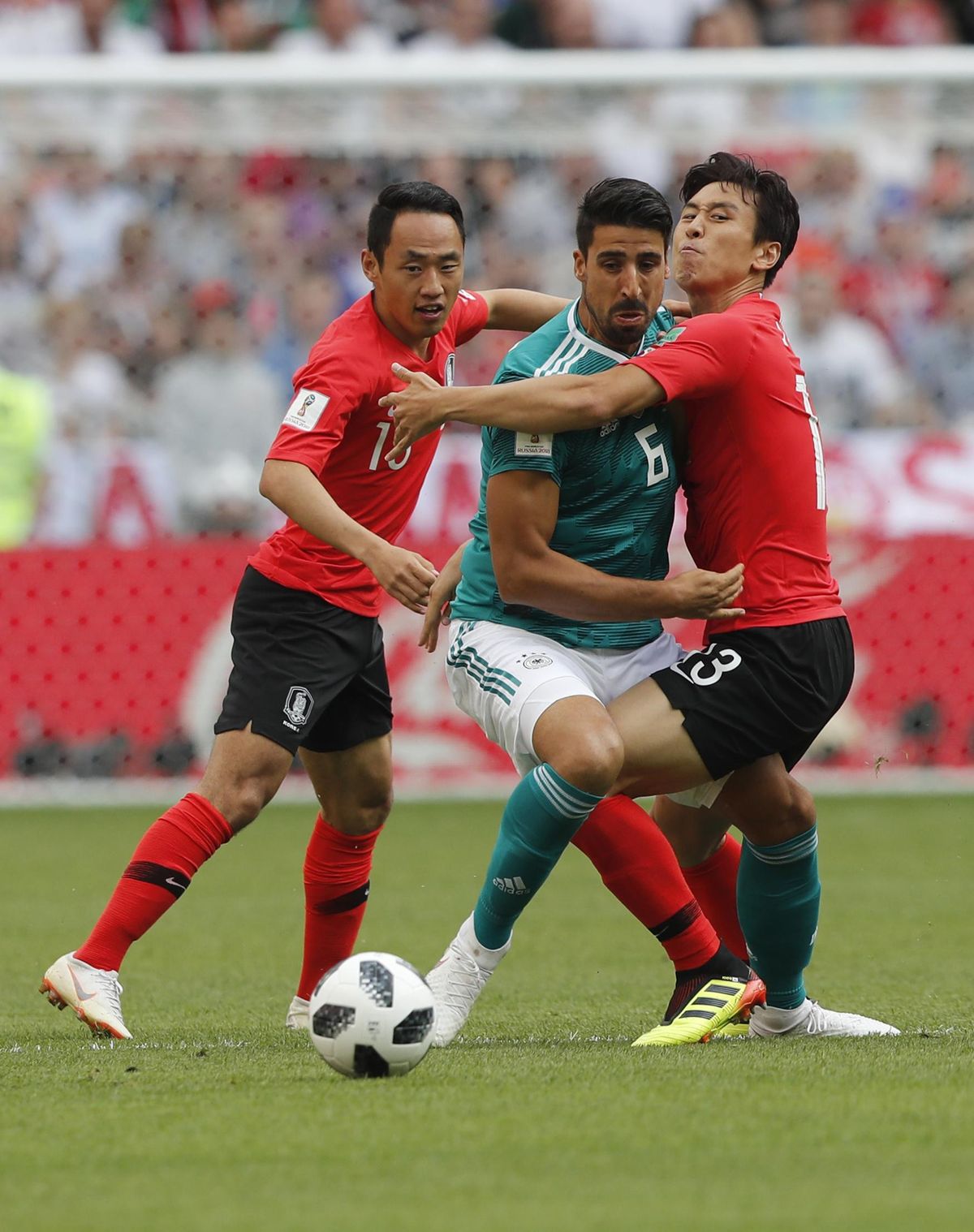 South Korea’s Koo Ja-cheol, right, and South Korea’s Moon Seon-min, left, vie for the ball with Germany’s Sami Khedira, centre, during the Group F match between South Korea and Germany, at the 2018 soccer World Cup in the Kazan Arena in Kazan, Russia, Wednesday, June 27, 2018. (Frank Augstein / Associated Press)