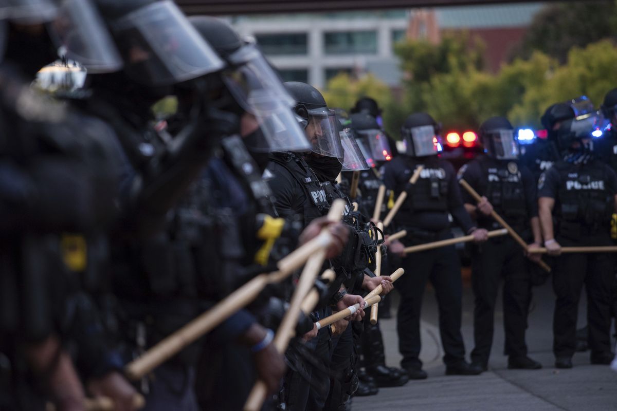 In this Sept. 25, 2020 photo, a line of police officers block protesters in Louisville, Ky. Most police officers who violate citizens’ rights get away with it because the law is heavily stacked in their favor, legal experts say.  (Isabel Miller)