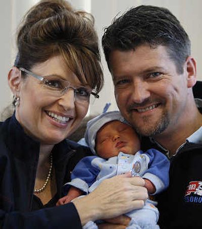 
Alaska Gov. Sarah Palin and her husband, Todd,  hold their baby boy Trig in Anchorage on April 23, five days after his birth. Associated Press
 (Associated Press / The Spokesman-Review)