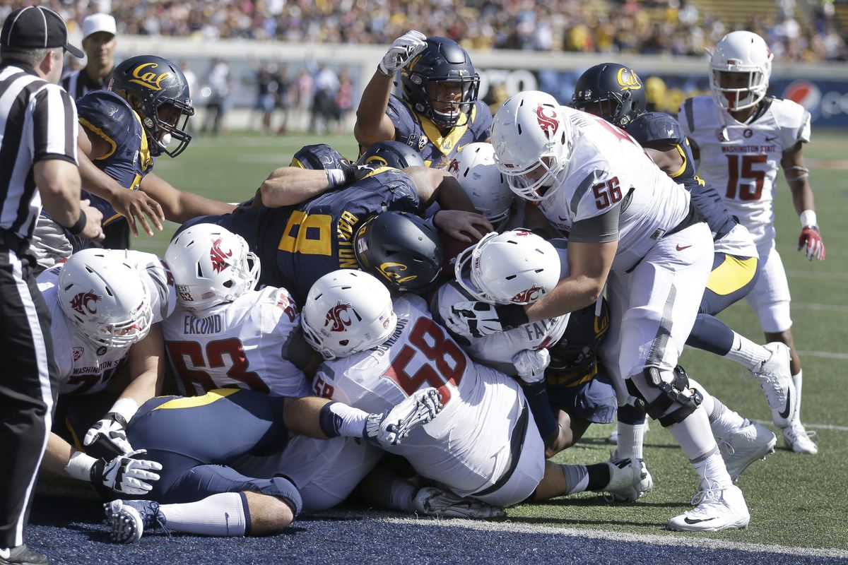 Washington State’s Joe Dahl (56) holds the head of quarterback Luke Falk as Falk scores a touchdown against California. (Associated Press)