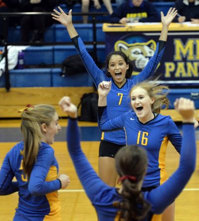 Mead’s Brianna Evans (7) and Maddy Soehren (16) celebrate a game point against University on Tuesday. (Jesse Tinsley)