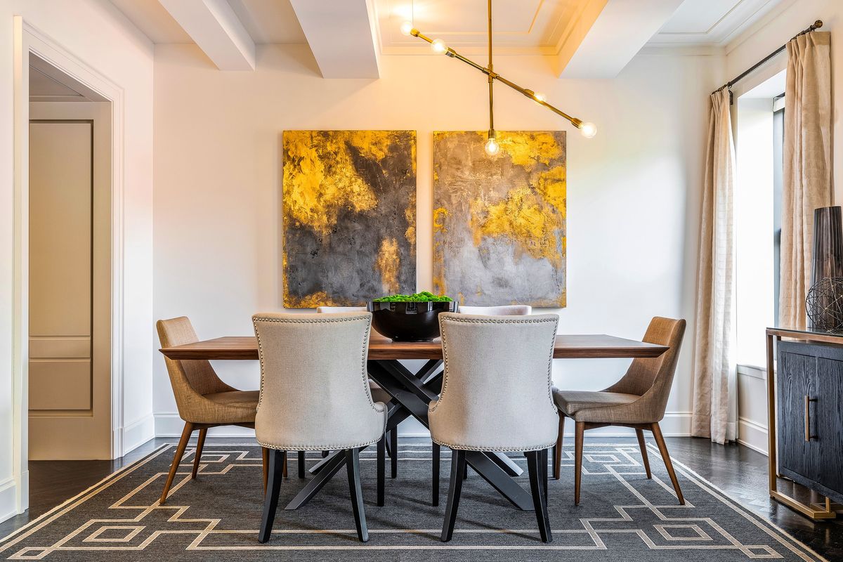 Two similar but not identical pieces of art blend silver and gold in this dining area. (Tribune News Service)