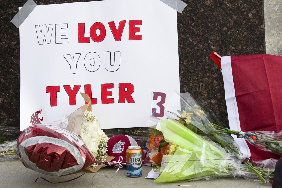 Items are left at a makeshift memorial for Washington State quarterback Tyler Hilinski outside Martin Stadium in Pullman, Wash., Wednesday, Jan. 17, 2018. (Geoff Crimmins / AP)