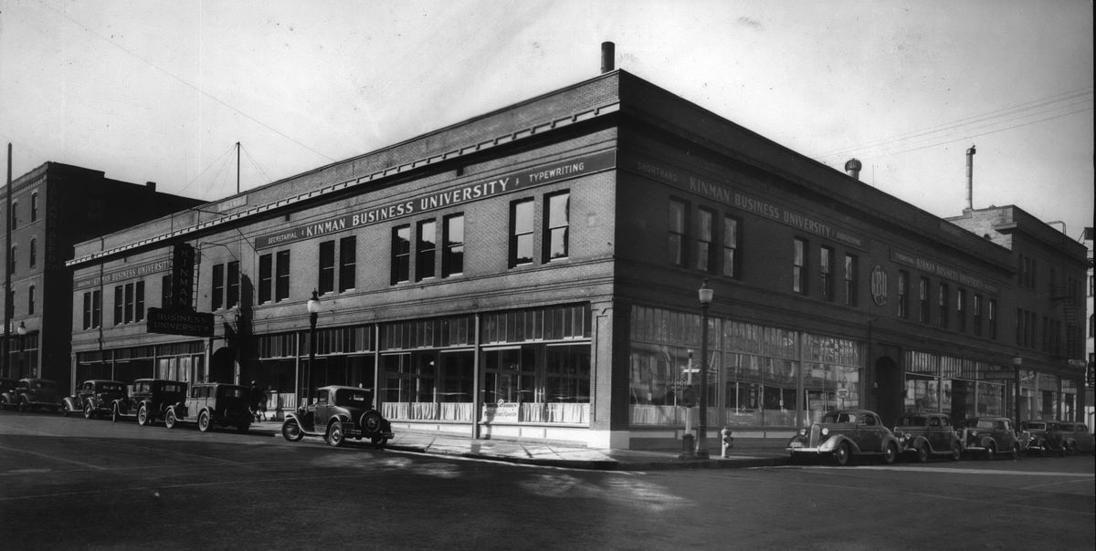 1936 - From the 1920s to the late 1960s, Kinman Business University, a private vocational school, was in the Kroll Building, formerly called the Merriam Block, at the southwest corner of Howard Street and First Avenue. (Libby Photographers / Libby Photographers)