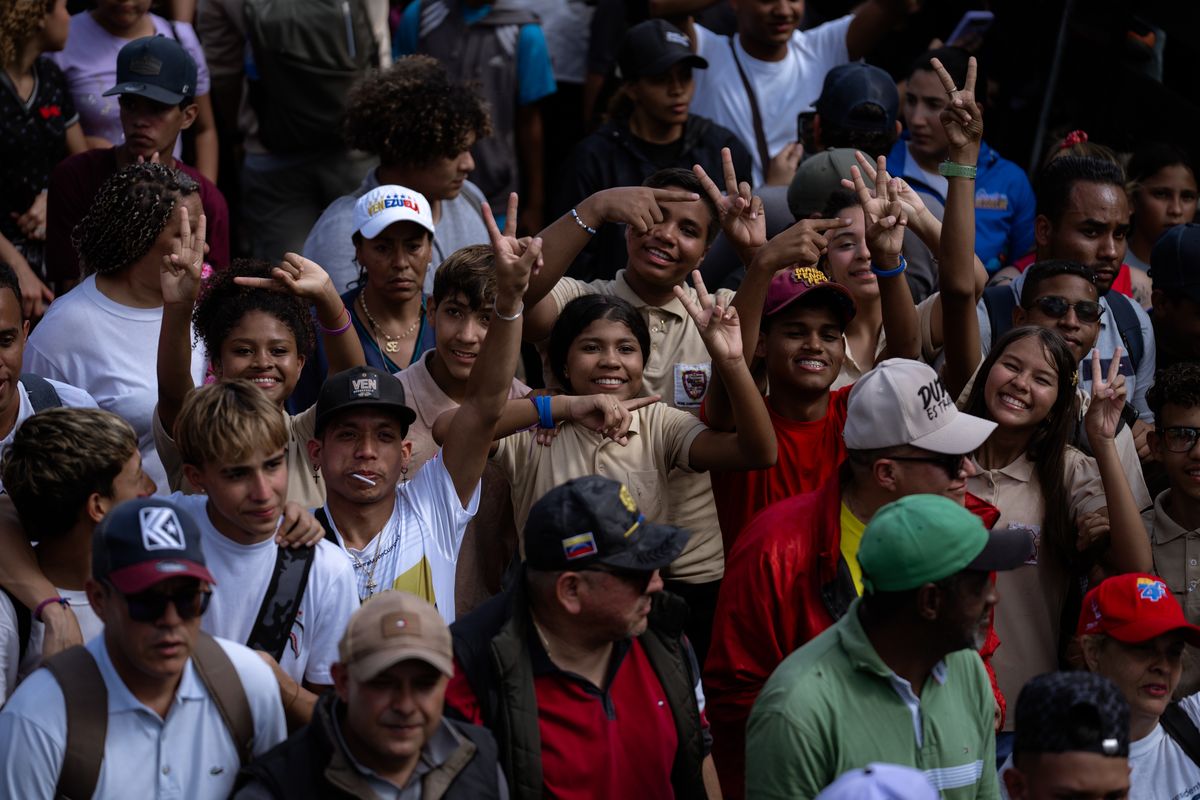 Teenagers make the Maduro salute on their way toward the Federal Legislative Palace in Caracas. MUST CREDIT: Andrea Hernández Briceño/For The Washington Post  (Andrea Hernández Briceño/For The Washington Post)