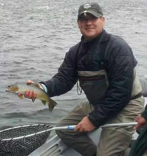 Fly fisher Mike Berube prepares to release a brown trout while fishing the Kootenai River in Montana. (Dan Ferguson)