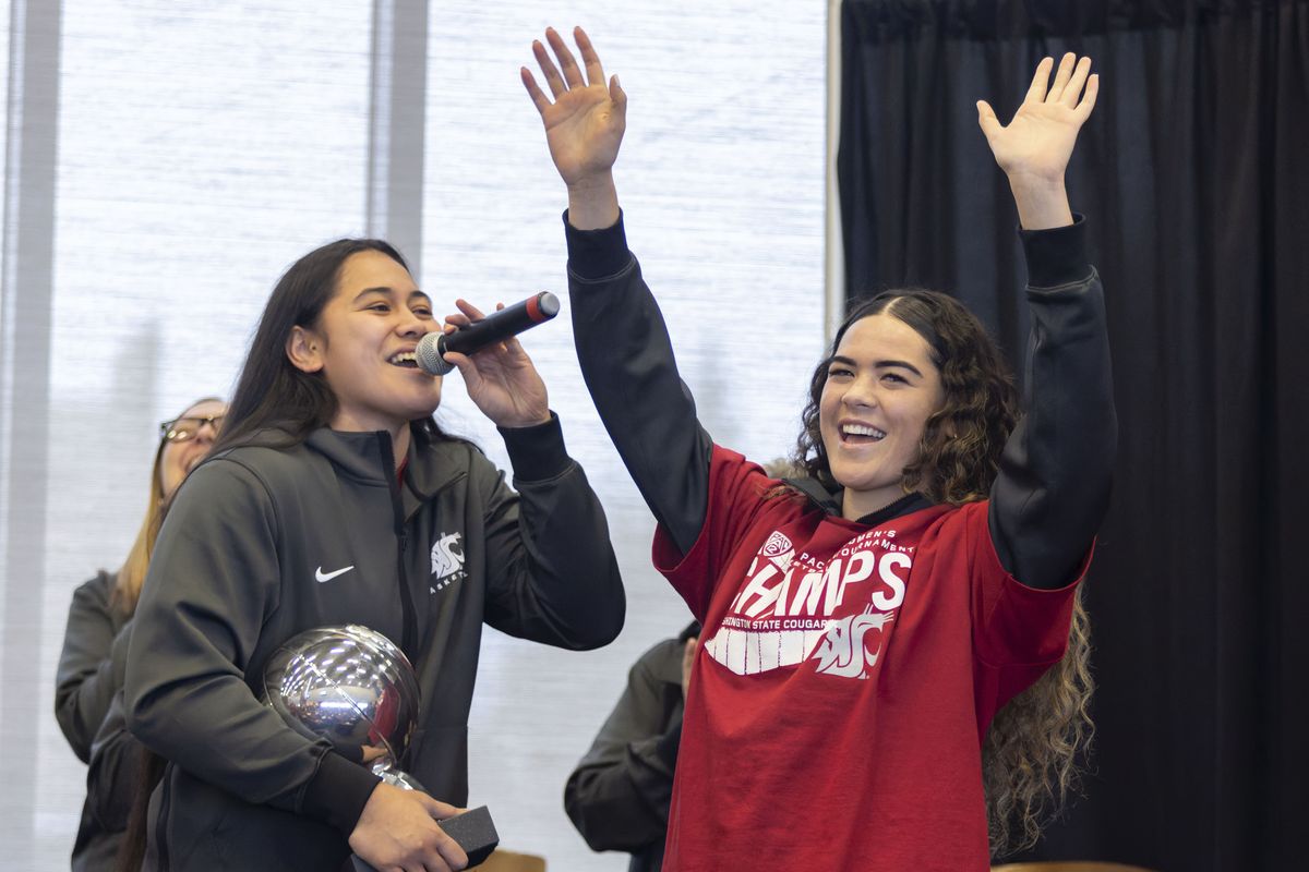 Washington State guard Charlisse Leger-Walker, right, is introduced by teammate Ula Motuga during an NCAA tournament selection watch party on Sunday at Gesa Field in Pullman.  (GEOFF CRIMMINS)