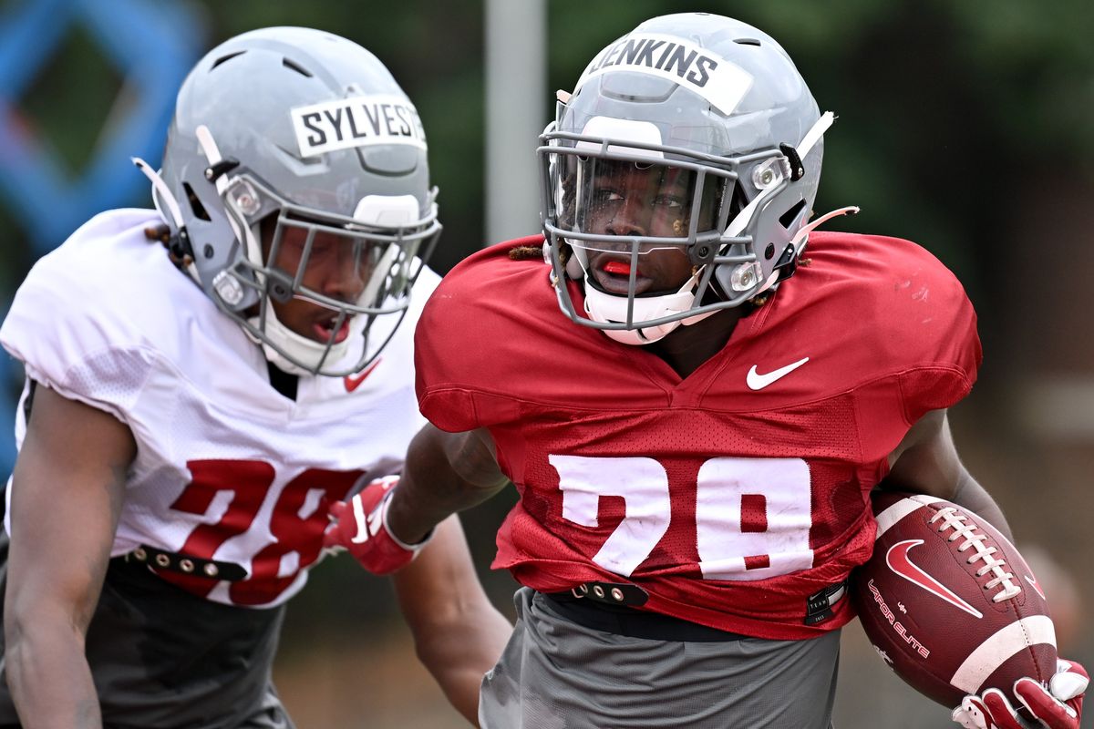 Washington State running back Jaylen Jenkins, right, carries the ball during a practice on Aug. 9 at Rogers Field in Pullman.  (Tyler Tjomsland/The Spokesman-Review)