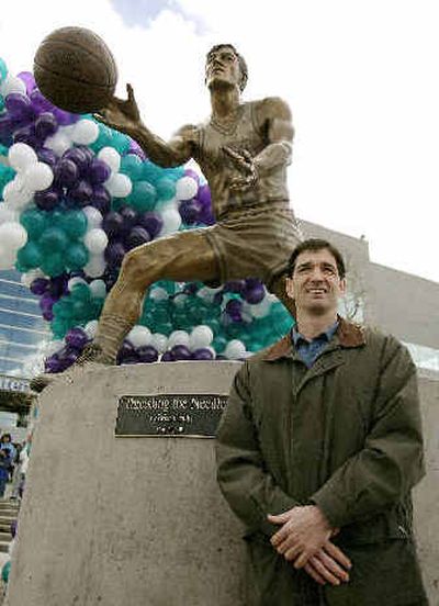 John Stockton poses with his statue in front of the Delta Center, home of Utah Jazz, in March 2005 in Salt Lake City. 
 (Associated Press / The Spokesman-Review)