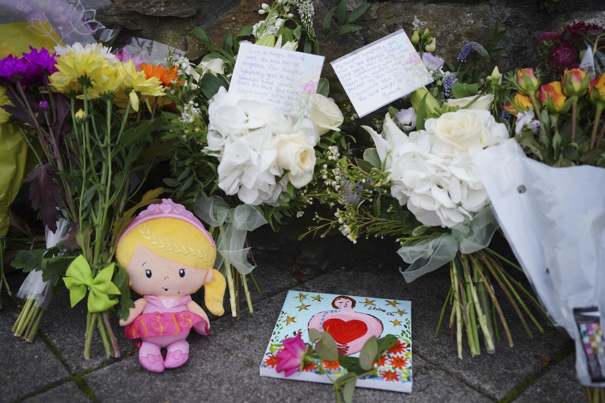 Flowers are left at the scene of a shooting in the Keyham area of Plymouth, England, Saturday, Aug. 14, 2021. Britain’s police watchdog says it has launched an investigation into why a 22-year-old man who fatally shot five people in southwestern England was given back his confiscated gun and gun license. Police have said Jake Davison killed his mother and four other people, including a 3-year-old girl, before taking his own life in Plymouth.  (Ben Birchall)