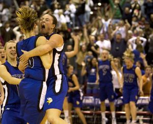 ORG XMIT: IDMC128 Coeur d' Alene's Kama Griffitts (10) and Whitney Heleker (30) celebrate their overtime win over Centential in the 5A Girls State Championship basketball game on Saturday, Feb. 21, 2009 in Nampa, Idaho.  Heleker hit a three-point shot to win the game with 1.7 seconds left on the clock.  Coeur d' Alene beat Centennial 54-50.  (AP Photo/Matt Cilley) (Matt Cilley / The Spokesman-Review)