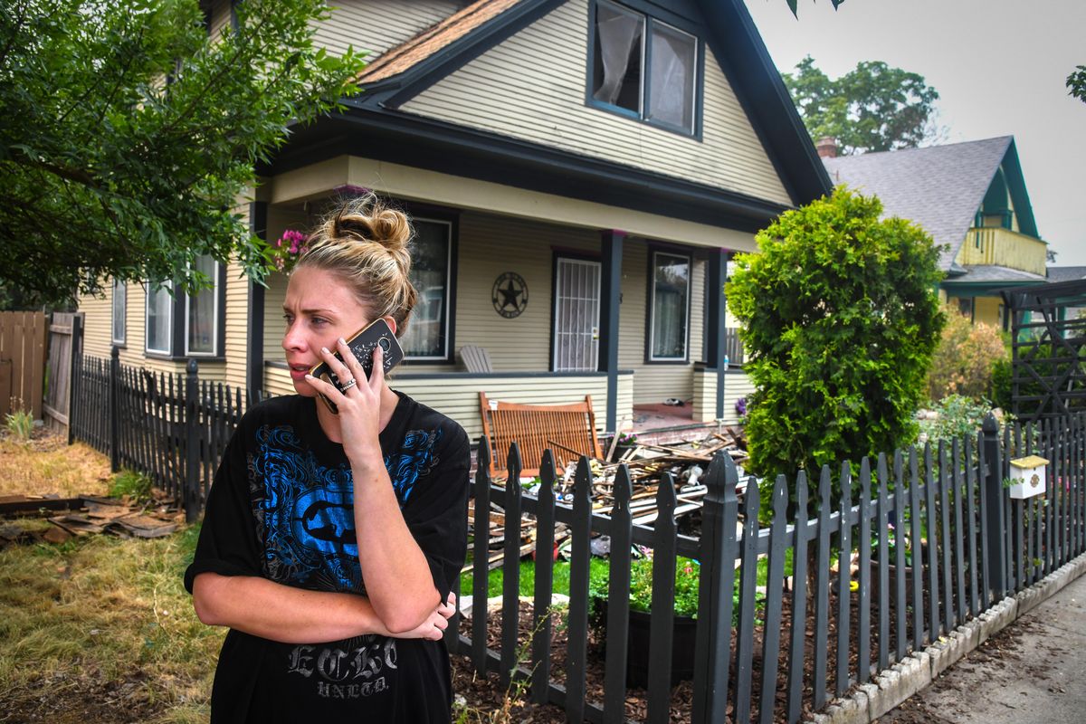 Barbara Summers talks on the phone Sunday morning after a fire burned her home at 808 E. Bridgeport Avenue in the early hours Aug. 19, 2018. (Dan Pelle / The Spokesman-Review)