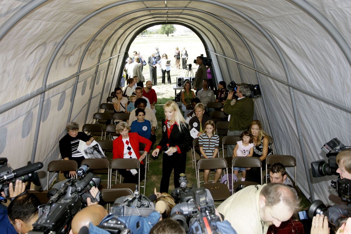Kate Hanni, founder of the Coalition for an Airline Passengers’ Bill of Rights, center, instructs participants inside a mock-up to simulate the airplane cabin experience during a demonstration located on the National Mall in Washington, D.C. Associated Press file photos (Associated Press file photos)