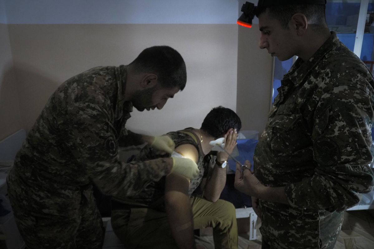 An Armenian wounded soldier receives treatment in a military hospital near the frontline in the separatist region of Nagorno-Karabakh, Sunday, Oct. 25, 2020. Armenia and Azerbaijan have accused each other of violating the new U.S.-brokered cease-fire aimed to halt the fighting over the separatist region of Nagorno-Karabakh. (STR)