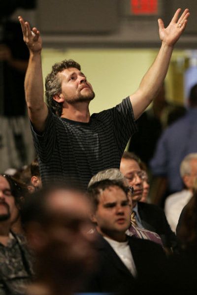 
A man looks heavenward during a community prayer service Tuesday in Leola, Pa.,  for those involved in a shooting Monday  at an Amish schoolhouse in nearby Nickel Mines. 
 (Associated Press / The Spokesman-Review)