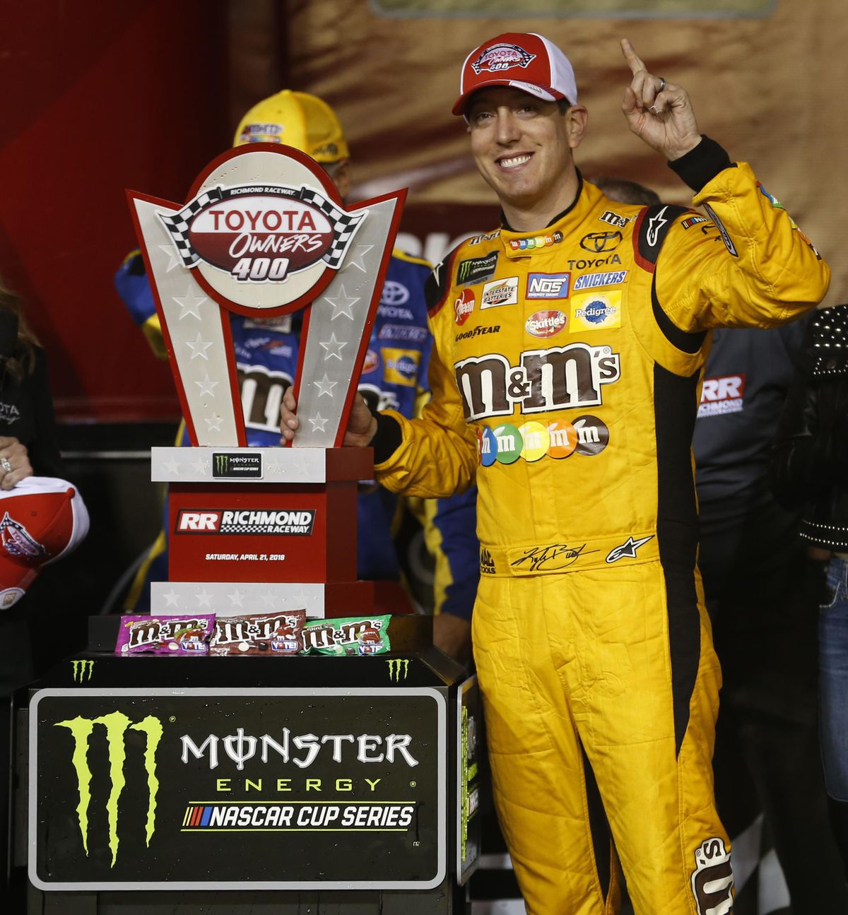 Kyle Busch poses with the winners trophy as he celebrates in Victory Lane after winning the NASCAR Cup Series auto race at Richmond Raceway in Richmond, Va., Saturday, April 21, 2018. (Steve Helber / Associated Press)