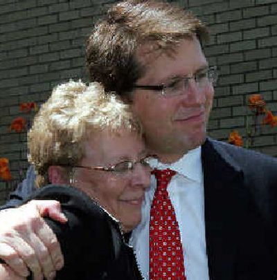 
Carol Ernst and attorney Mark Lanier hug as they face the microphones Friday after winning her case.
 (Associated Press / The Spokesman-Review)