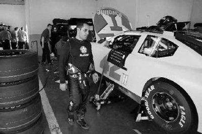 
Juan Pablo Montoya checks on his car while crew members make adjustments at Daytona International Speedway.
 (Associated Press / The Spokesman-Review)