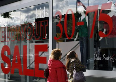 Store banners offer discounted prices this week in Beverly Hills, Calif. The retail industry expects its first sales decline in almost 40 years.  (Associated Press / The Spokesman-Review)