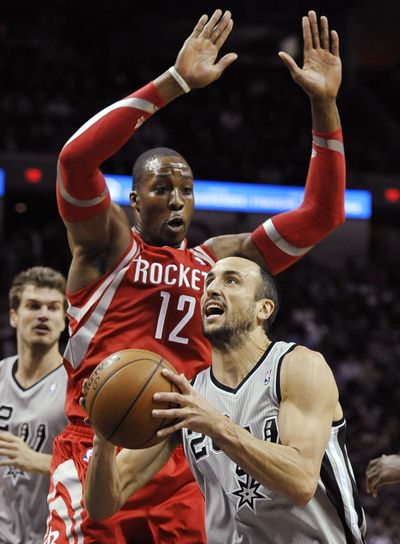 Dwight Howard (12) and the Rockets contained the Spurs Saturday. (Associated Press)