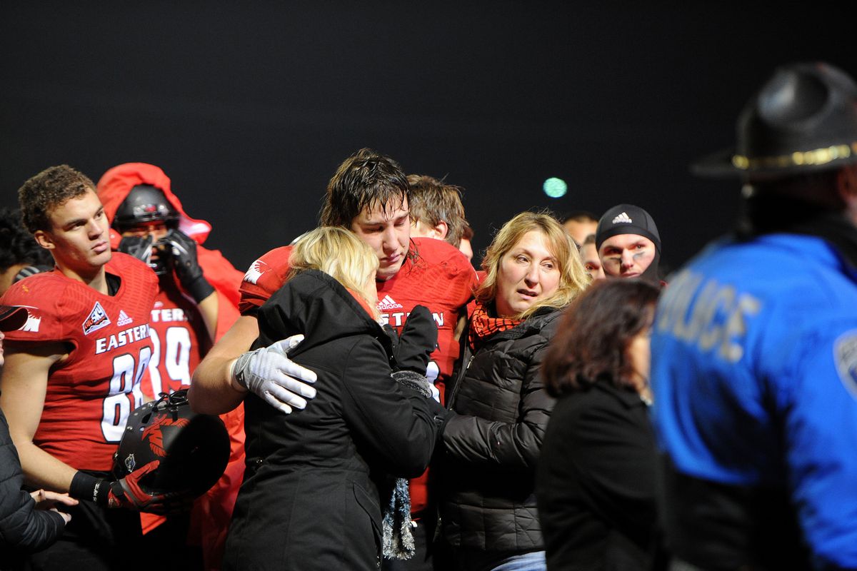 Eastern Washington’s Jake Rodgers is embraced after his father was taken by ambulance to the hospital. (Tyler Tjomsland)