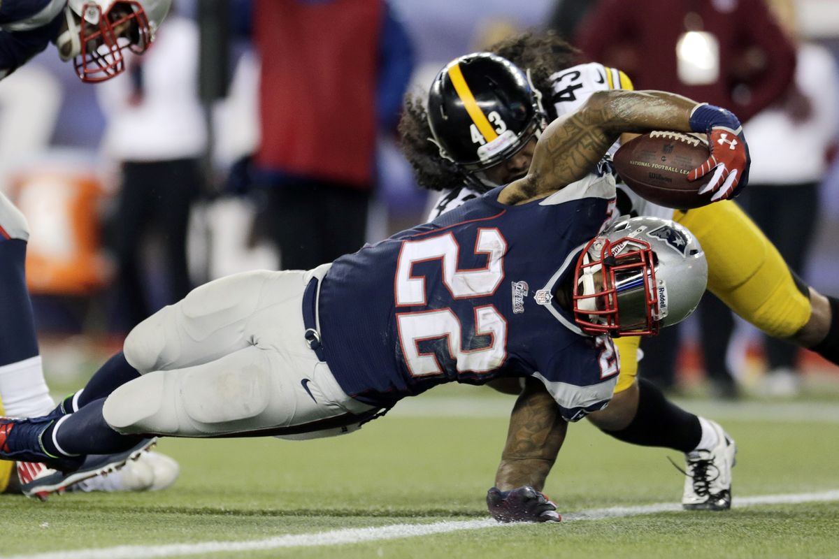 Patriots running back Stevan Ridley scores in front of Steelers safety Troy Polamalu in the fourth quarter. (Associated Press)