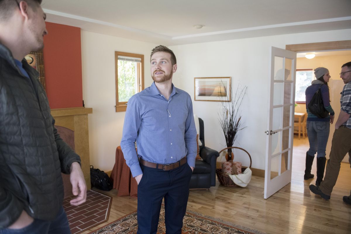 Real estate agent Perry Domini, center, chats with Darren Kentner, left, an agent from Bellevue, Washington, during an open house Sunday, April 16, 2017, at a small home on Spokane’s South Hill. The house, priced at $197,000 and situated in the Manito Park area, was the least expensive house with an open house on Sunday, though there weren’t many open houses scheduled this early in the season. Kentner said that in Bellevue the average home price is nearly $800,000. (Jesse Tinsley / The Spokesman-Review)
