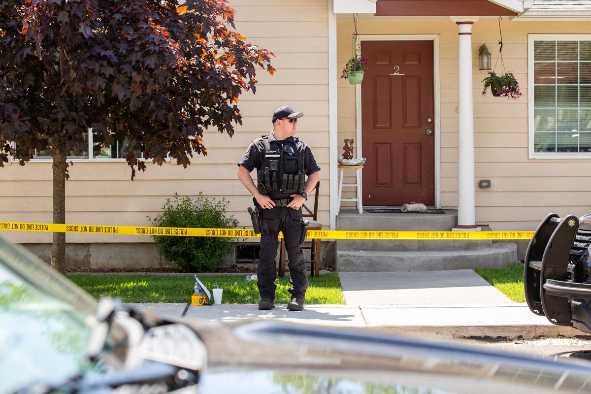 Officer Josh Laiva watches the perimeter at Fifth and Fiske in Spokane on May 20, 2019 following a shooting. This is the second shooting at this location since April 29. (Libby Kamrowski / The Spokesman-Review)
