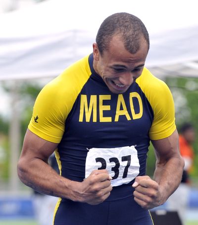 Mead's Davian Barlow celebrates as his name appears on the scoreboard as winner of the 4A 100m dash Saturday, May 18, 2013 at the 3A/4A Regionals in track at Spokane Falls Community College. (Jesse Tinsley / The Spokesman-Review)