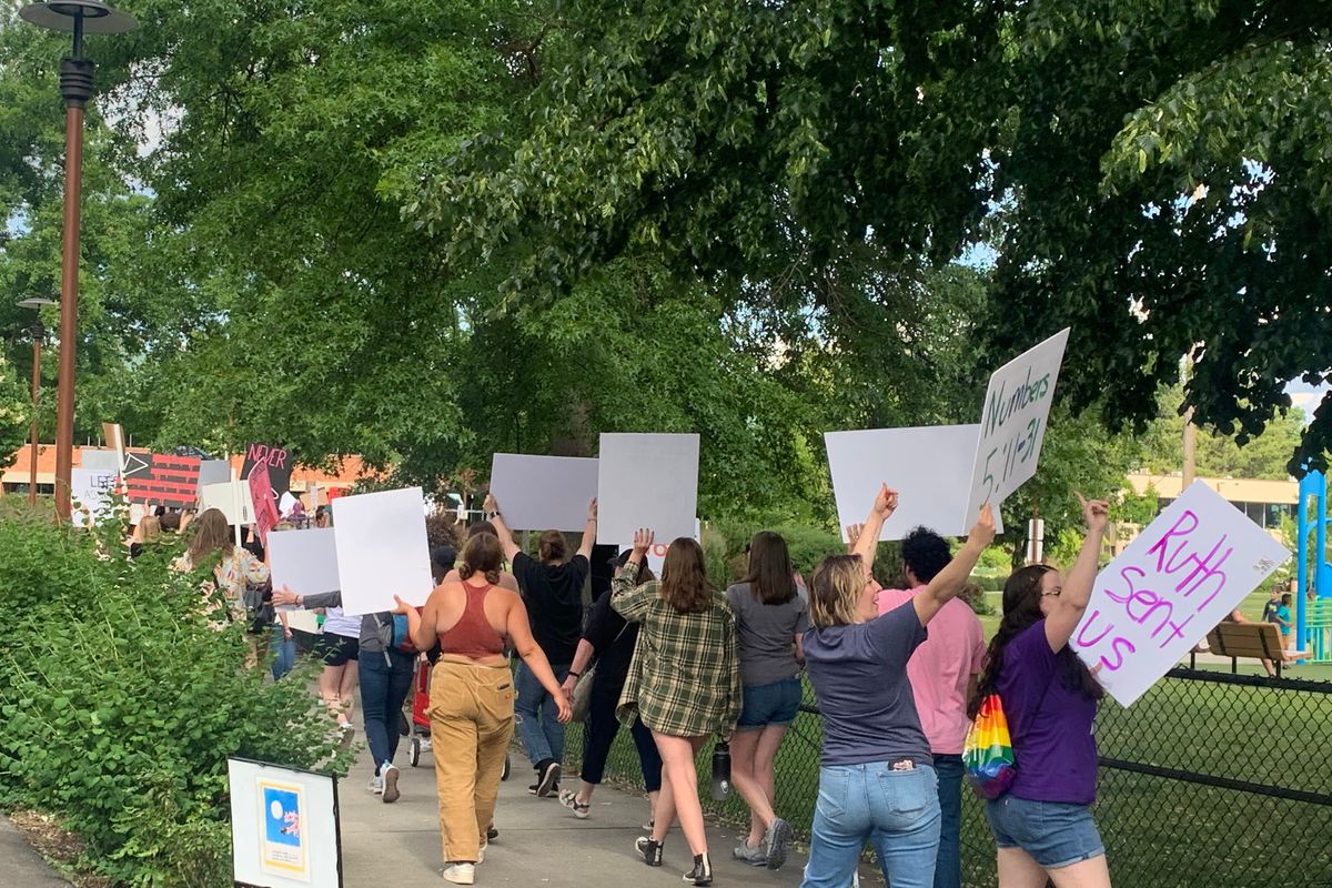 Protestors for the overturn of Roe V Wade marching down the pathway of the park near Coeur d