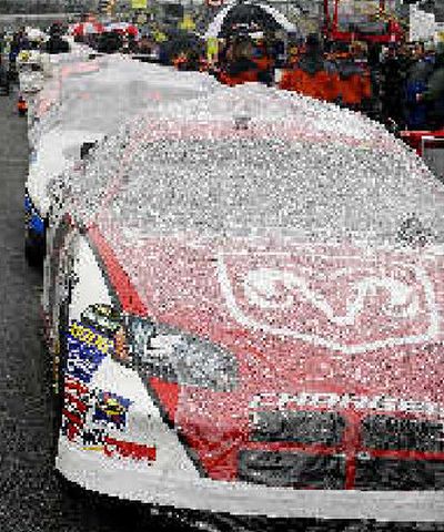 
Race cars are covered in plastic as rain delayed the Golden Corral 500. 
 (Associated Press / The Spokesman-Review)