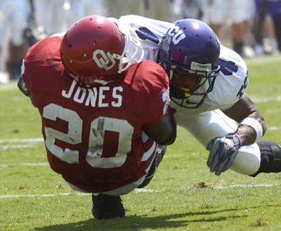 
TCU's Quincy Butler levels Oklahoma running back Kejuan Jones in the Horned Frogs' upset victory on Saturday.
 (Associated Press / The Spokesman-Review)