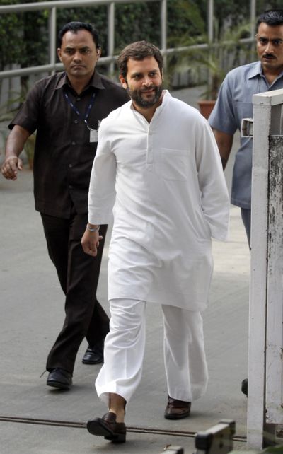 Congress party leader Rahul Gandhi walks to meet the media in New Delhi Tuesday. India's ruling Congress party trailed far behind its rivals in early returns from a key state election Tuesday. (Associated Press)