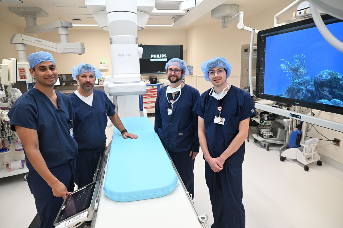 From left, vascular surgeon Dr. Jaideep Das Gupta, Catheter Lab Manager Brian Watson, technicians Kegan Orpin and Niki Johnson stand in the newest catheter lab Wednesday at Deaconess Medical Center where the latest technology allows for catheter procedures and enhanced imaging for a wide variety of procedures. The technology for frequent real-time imaging of patients while on the table is as advanced as any other lab on the west coast, according to Dr. Das Gupta. (Jesse Tinsley/The Spokesman-Review)