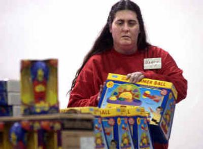 
Nancy Bottke stacks toys at the Christmas Bureau in Spokane last week. Bottke, a past recipient of the bureau's assistance, helps out there now by volunteering.
 (Brian Plonka / The Spokesman-Review)