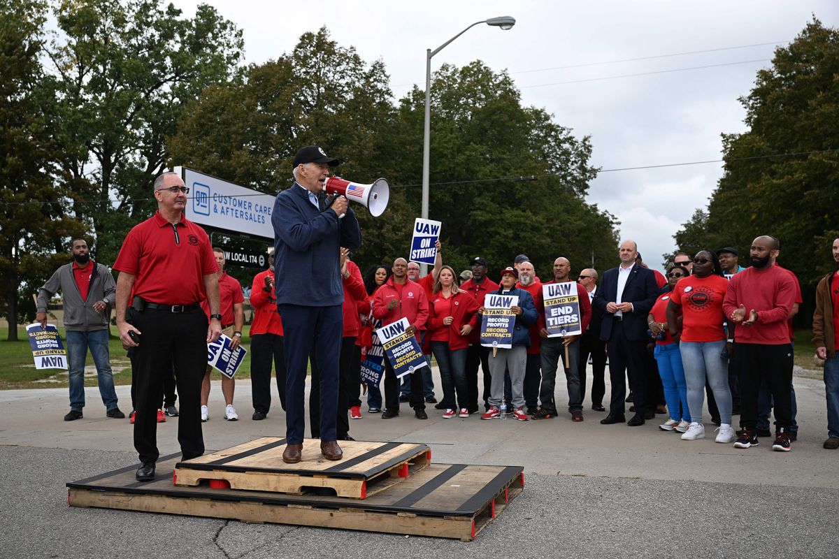 President Joe Biden addresses striking members of the United Auto Workers union at a picket line outside a General Motors Service Parts Operations plant on Tuesday in Belleville, Mich.  (Jim Watson/AFP/GETTY IMAGES NORTH AMERICA/TNS)