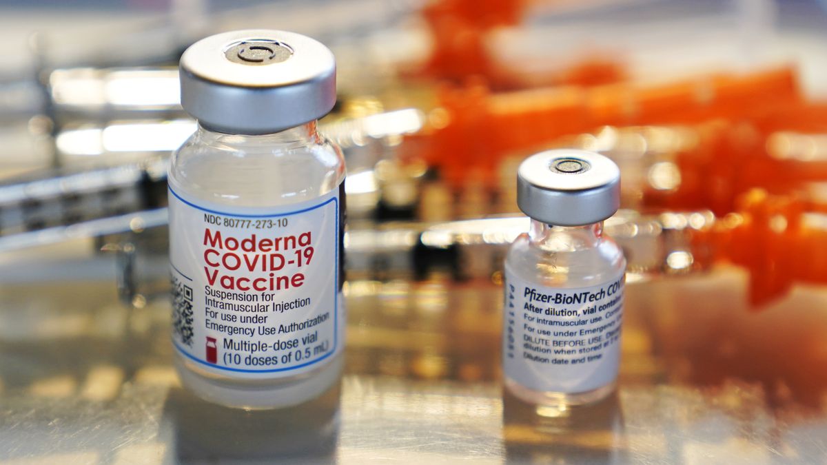 FILE - In this Feb. 25, 2021, file photo, vials for the Moderna and Pfizer COVID-19 vaccines are displayed on a tray at a clinic set up by the New Hampshire National Guard in the parking lot of Exeter, N.H., High School. An untold number of Americans have managed to get COVID-19 booster shots even though the U.S. government hasn't approved them. They're doing so by taking advantage of the nation’s vaccine surplus and loose tracking of those who have been fully vaccinated. (Charles Krupa)