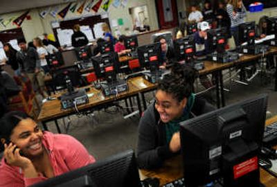 Roberta Devine, a senior, left, jokes with her friend Wasedra Roark, a junior, in the library while waiting for WASL testing to finish Monday at North Central High School in Spokane.
(Rajah Bose / The Spokesman-Review)