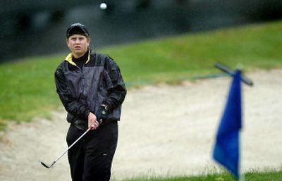 
Shadle Park's Tyler Nelson works on his chipping during a practice round at The Creek at Qualchan for the State 4A boys golf tournament that opens there today. 
 (Joe Barrentine / The Spokesman-Review)