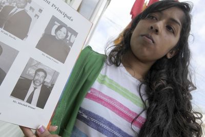 Eighth-grader Anita Seeratan, 13,  holds up a yearbook Friday with a photograph of Susan B. Anthony Intermediate School assistant Principal Mitchell Wiener.  (File Associated Press / The Spokesman-Review)