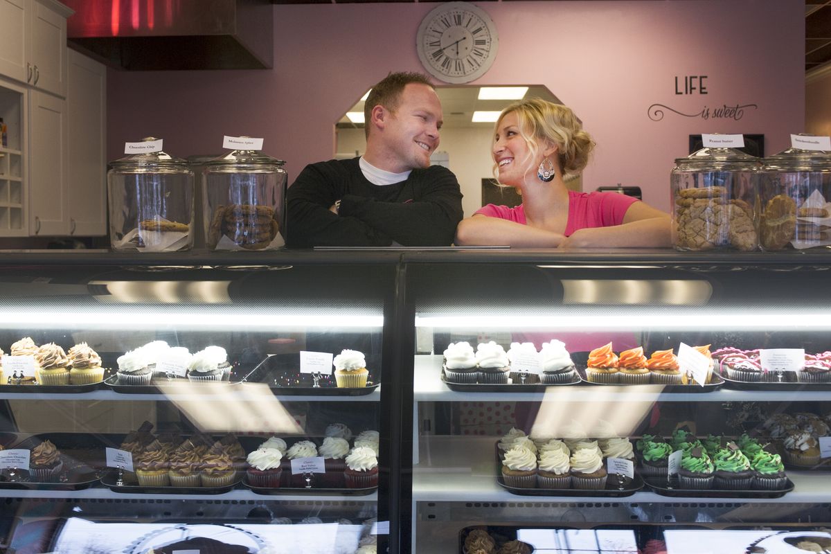 Joe and Amber Owens smile at each other at their new Spokane Valley location for Celebrations Bakery on Thursday. (Tyler Tjomsland)