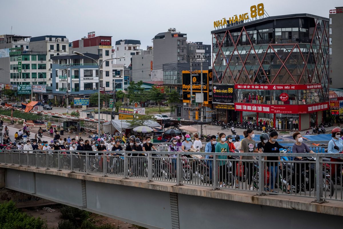 Workers head to the Van Trung Industrial Park in Bac Giang province, Vietnam, on Aug. 20. Worried about geopolitical tensions and stung by pandemic shutdowns, Google, Apple and others are moving some work to nearby countries.  (New York Times)