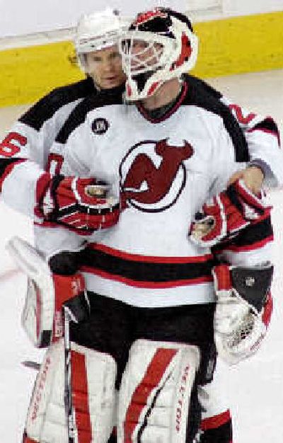 
Patrik Elias consoles New Jersey goalie Martin Brodeur. 
 (Associated Press / The Spokesman-Review)