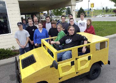
Members of a Riverbend Professional Technical Academy class that built a miniature vehicle gather around it at its unveiling River City Yamaha in Post Falls. 
 (Jesse Tinsley / The Spokesman-Review)