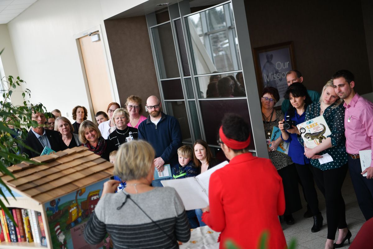 Laura Brincken and her husband Cody, far right, parents of Isaac Brincken, who at five-months-old succumbed to Complications with CHARGE syndrome, listen as "Issac's Bookshelf" is dedicated in his honor on Monday, Feb. 18, 2019, at Sacred Heart Hospital in Spokane, Wash. Isaac's Bookshelf was created in his memory to share the joy of reading with children who are in the hospital undergoing treatment for complex medical conditions. The bookshelf rolls around the unit visiting patients. (Tyler Tjomsland / The Spokesman-Review)